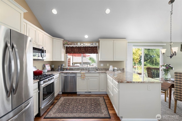 9619 Windswept Ln NW, Silverdale, WA 98383 - kitchen with stainless steel appliances, a peninsula, plenty of natural light, lofted ceiling, and a chandelier