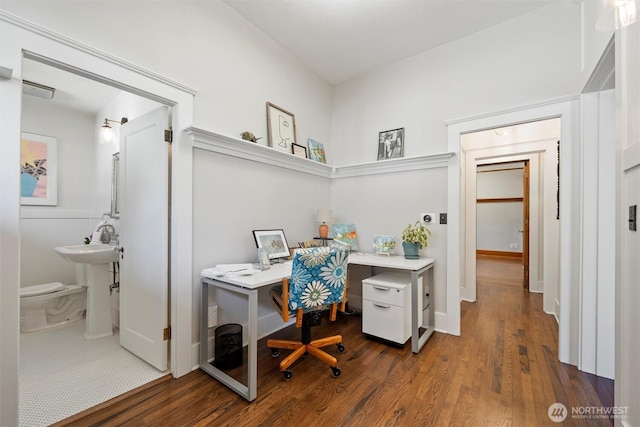 office area with dark wood-style floors and a sink
