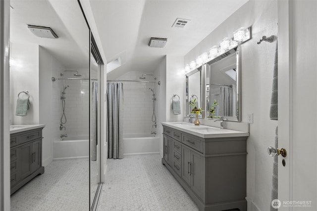 full bath with shower / bath combo with shower curtain, double vanity, and tile patterned floors