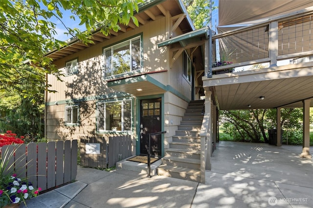view of exterior entry with a patio area