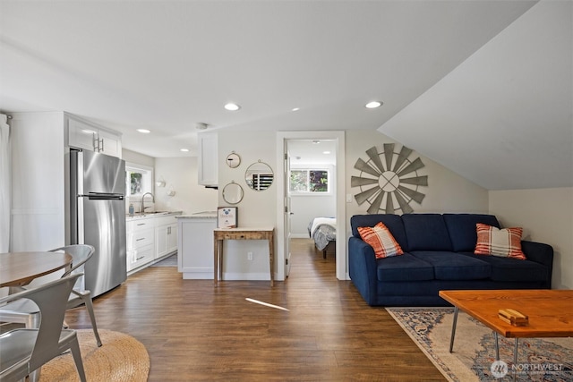 living room with dark wood-type flooring and recessed lighting
