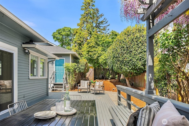 deck with a fenced backyard, entry steps, and outdoor lounge area
