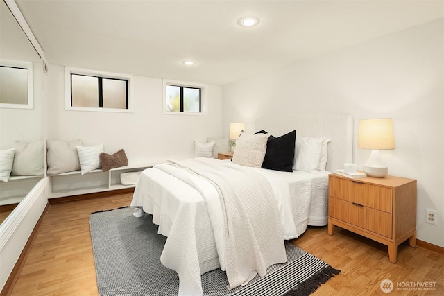 bedroom featuring light wood-type flooring, recessed lighting, and baseboards