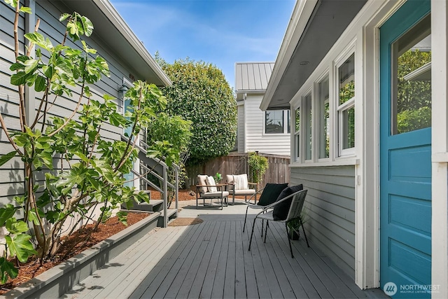 wooden terrace featuring fence
