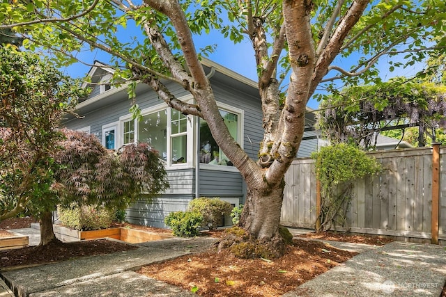 view of home's exterior featuring fence