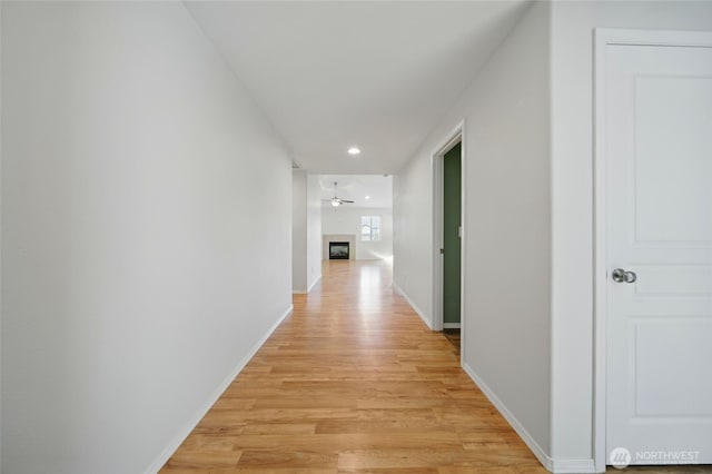 hall with light wood-type flooring, recessed lighting, and baseboards