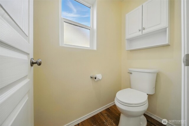 bathroom featuring baseboards, toilet, and wood finished floors