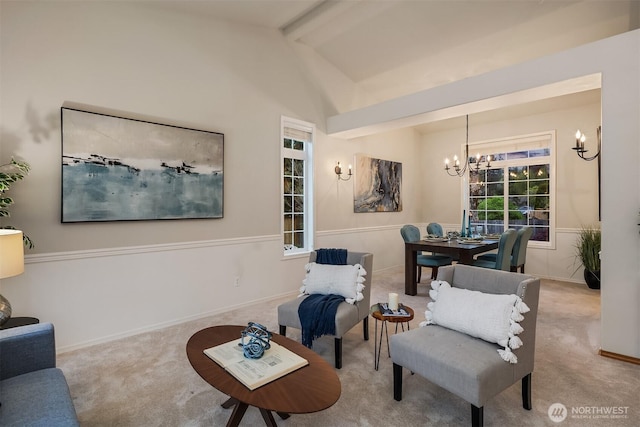 sitting room with a chandelier, carpet floors, and baseboards
