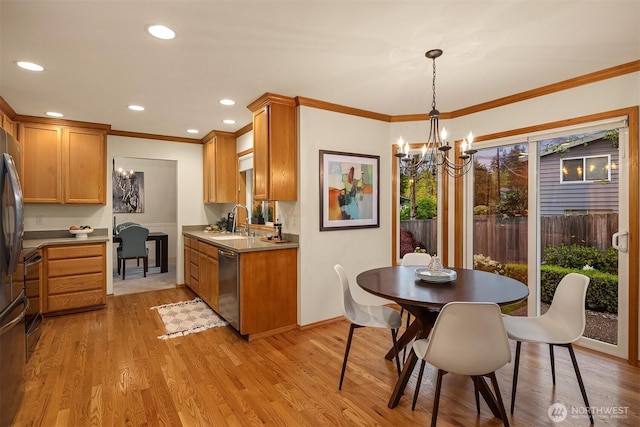 kitchen with stainless steel dishwasher, ornamental molding, light wood finished floors, a chandelier, and a sink