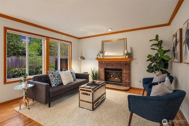 living room featuring wood finished floors, baseboards, a fireplace, ornamental molding, and recessed lighting