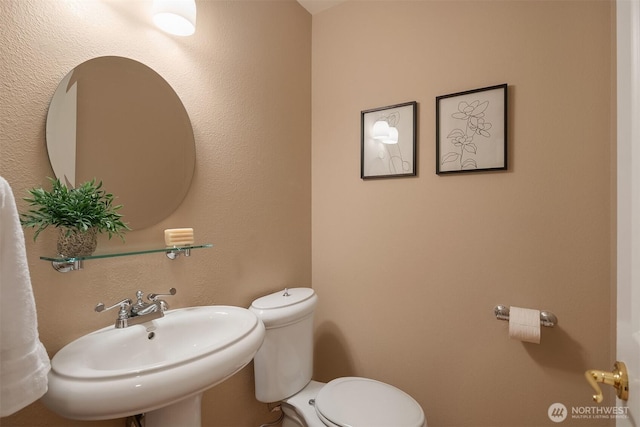 bathroom with a sink and toilet