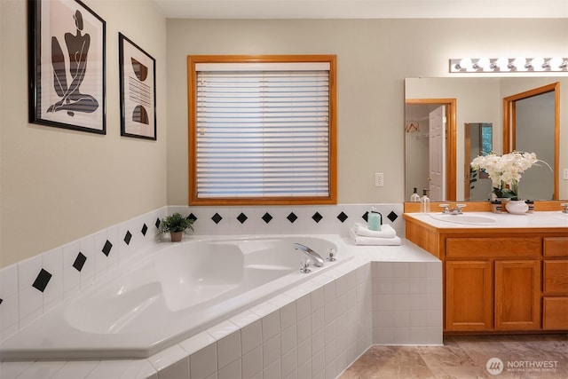 full bath featuring a garden tub and vanity