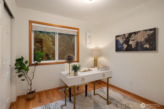 office area with wood finished floors and baseboards