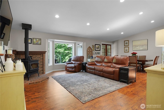 1120 Maple Valley Rd SW, Olympia, WA 98512 - living area featuring a wood stove, wood finished floors, and recessed lighting