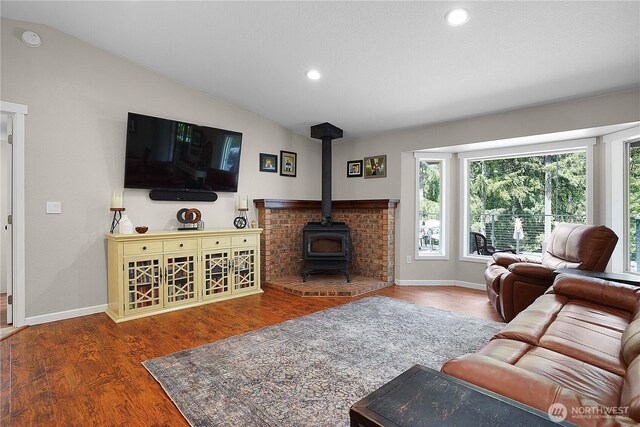 1120 Maple Valley Rd SW, Olympia, WA 98512 - living area featuring vaulted ceiling, a wood stove, wood finished floors, baseboards, and recessed lighting