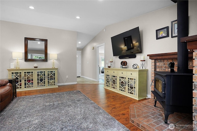 1120 Maple Valley Rd SW, Olympia, WA 98512 - living area with a wood stove, wood finished floors, vaulted ceiling, baseboards, and recessed lighting