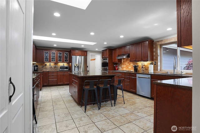 1120 Maple Valley Rd SW, Olympia, WA 98512 - kitchen with appliances with stainless steel finishes, a sink, a skylight, decorative backsplash, and recessed lighting