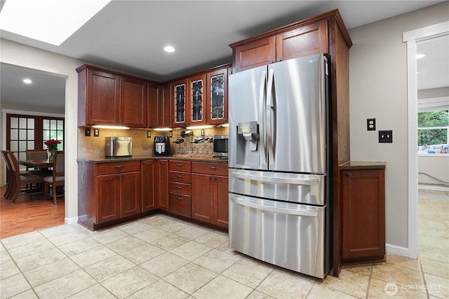 1120 Maple Valley Rd SW, Olympia, WA 98512 - kitchen featuring stainless steel appliances, backsplash, recessed lighting, glass insert cabinets, and dark stone counters