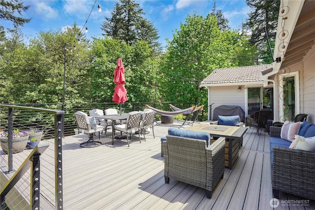 1120 Maple Valley Rd SW, Olympia, WA 98512 - wooden terrace with outdoor dining space, an outdoor living space, and view of wooded area