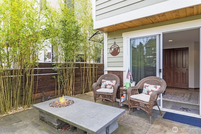 view of patio with fence and an outdoor fire pit