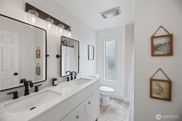 full bath with toilet, double vanity, and curtained shower