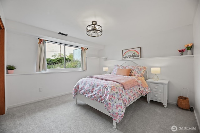 carpeted bedroom featuring baseboards