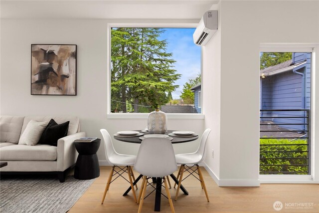 1911C N 120th St, Seattle, WA 98133 - dining area with a wall mounted air conditioner, wood finished floors, and baseboards