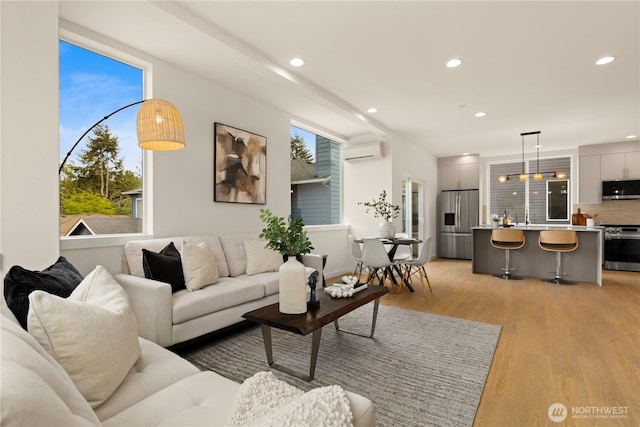 1911C N 120th St, Seattle, WA 98133 - living room with a wall mounted AC, recessed lighting, light wood finished floors, and healthy amount of natural light