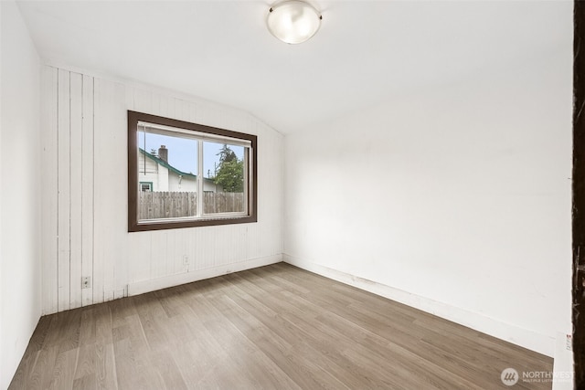 bonus room with wood finished floors, lofted ceiling, and baseboards