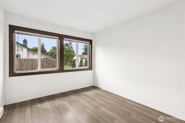 unfurnished room with wood finished floors