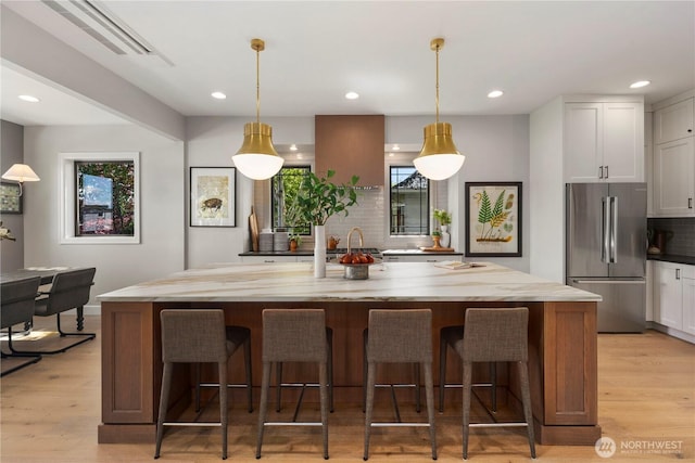 3018 22nd Ave W, Seattle, WA 98199 - kitchen with freestanding refrigerator, tasteful backsplash, white cabinetry, light wood finished floors, and recessed lighting