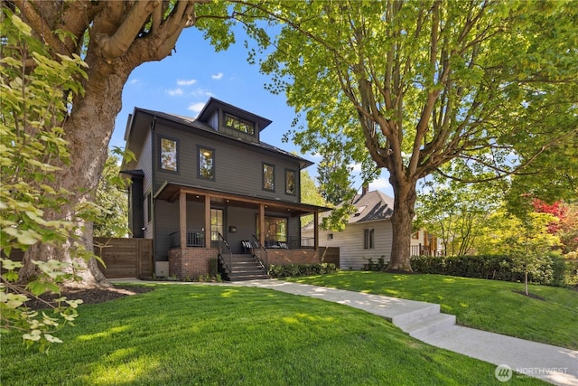 3018 22nd Ave W, Seattle, WA 98199 - traditional style home with a front yard, stairway, covered porch, and brick siding