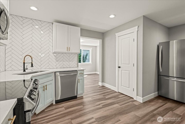 821 15th St, Bremerton, WA 98337 - kitchen featuring stainless steel appliances, tasteful backsplash, recessed lighting, light countertops, and white cabinets