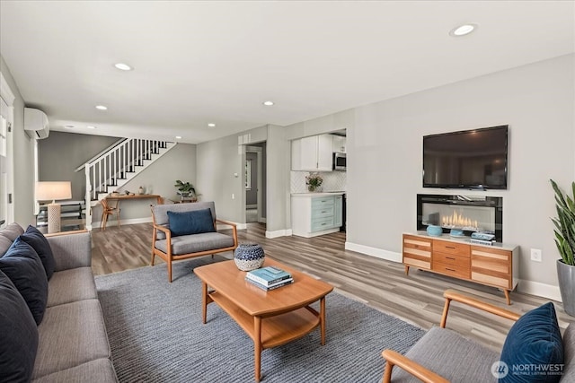 821 15th St, Bremerton, WA 98337 - living room featuring stairway, a wall mounted AC, wood finished floors, and recessed lighting
