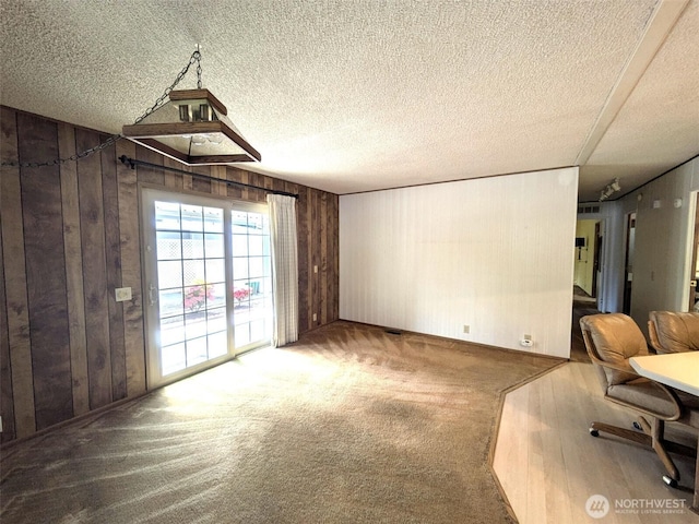 201 Union Ave SE Unit 234, Renton, WA 98059 - unfurnished dining area with wood walls, carpet floors, and a textured ceiling