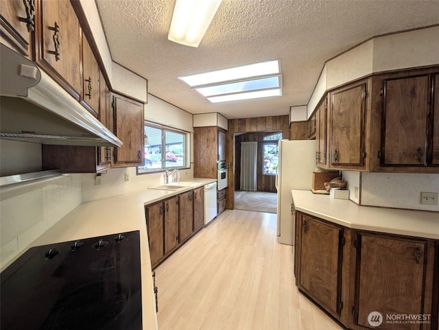 201 Union Ave SE Unit 234, Renton, WA 98059 - kitchen featuring white dishwasher, black electric cooktop, a textured ceiling, a sink, and oven
