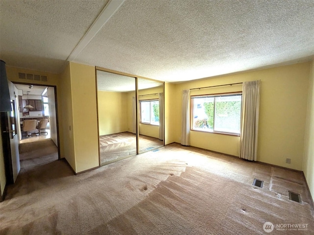 201 Union Ave SE Unit 234, Renton, WA 98059 - unfurnished bedroom with a textured ceiling, carpet floors, and a closet
