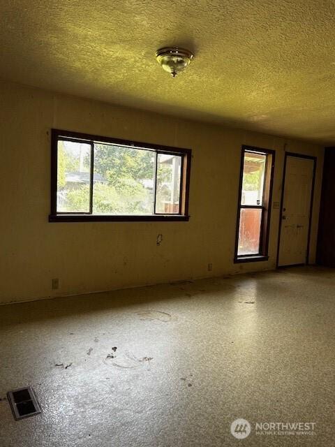 spare room with a textured ceiling