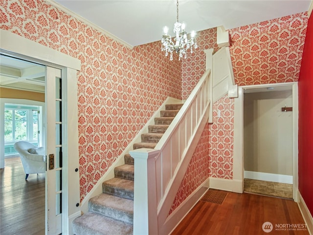 215 N Forest St, Bellingham, WA 98225 - stairway with wallpapered walls, wood finished floors, and a chandelier