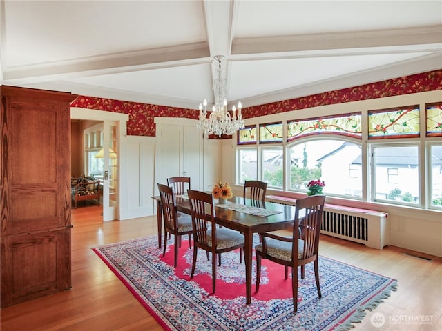 215 N Forest St, Bellingham, WA 98225 - dining space featuring beamed ceiling, plenty of natural light, a chandelier, light wood-style floors, and a decorative wall