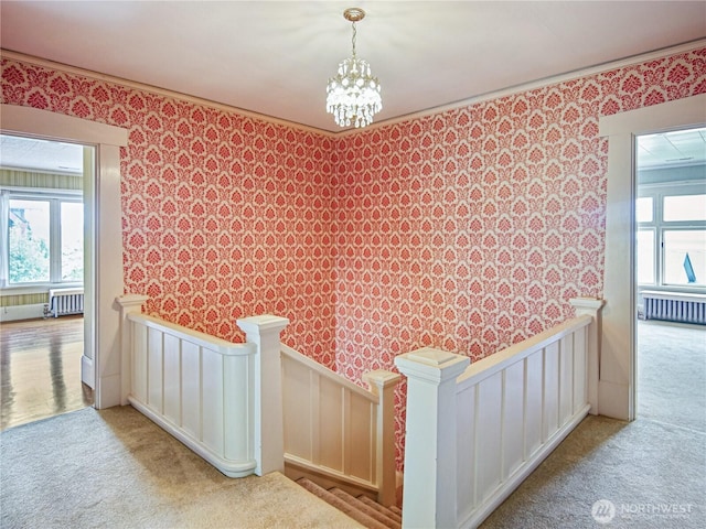 215 N Forest St, Bellingham, WA 98225 - hall featuring wallpapered walls, radiator, an upstairs landing, carpet floors, and wainscoting