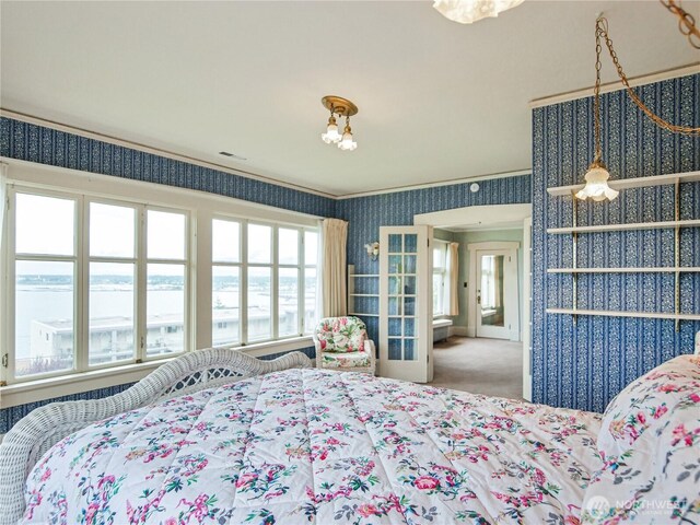 215 N Forest St, Bellingham, WA 98225 - carpeted bedroom with wallpapered walls, multiple windows, and ornamental molding