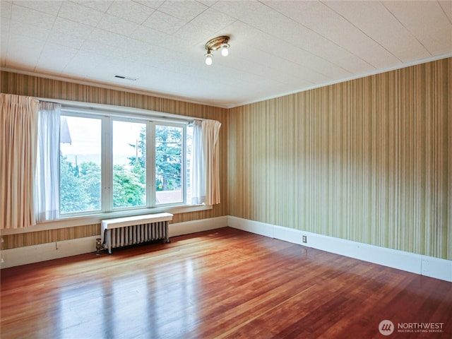 215 N Forest St, Bellingham, WA 98225 - spare room with radiator heating unit and wood finished floors