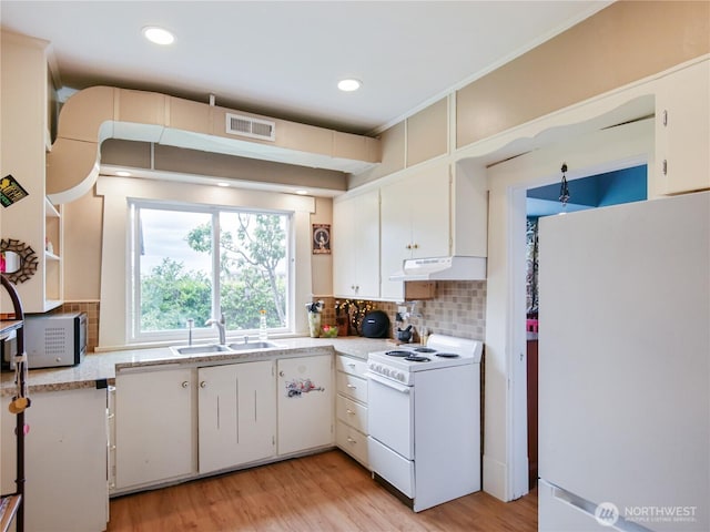 215 N Forest St, Bellingham, WA 98225 - kitchen featuring white appliances, light countertops, under cabinet range hood, decorative backsplash, and recessed lighting