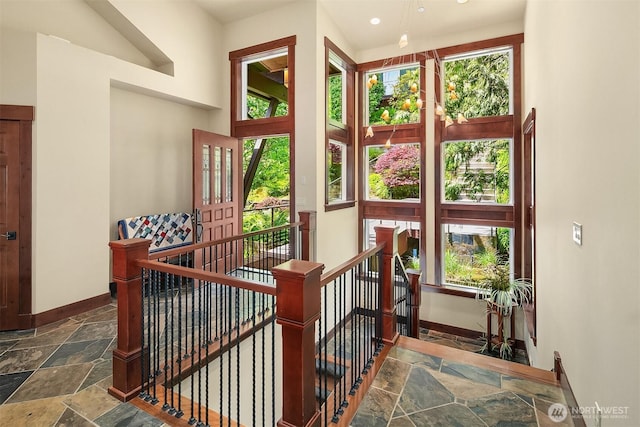 1624 Mallard Ln, Bellevue, WA 98008 - stairway featuring stone tile floors, plenty of natural light, baseboards, and recessed lighting
