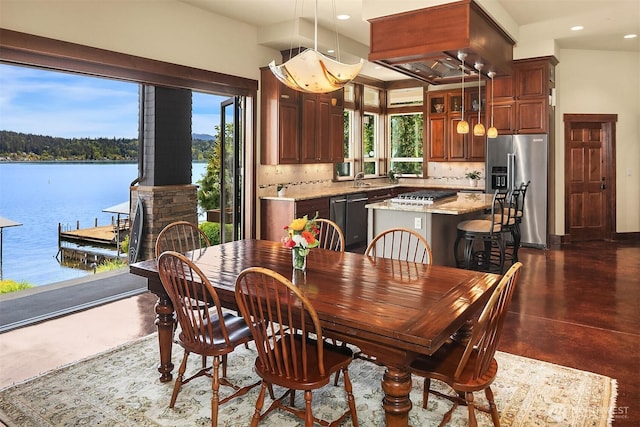 1624 Mallard Ln, Bellevue, WA 98008 - dining room with concrete flooring, recessed lighting, a wood stove, and a water view