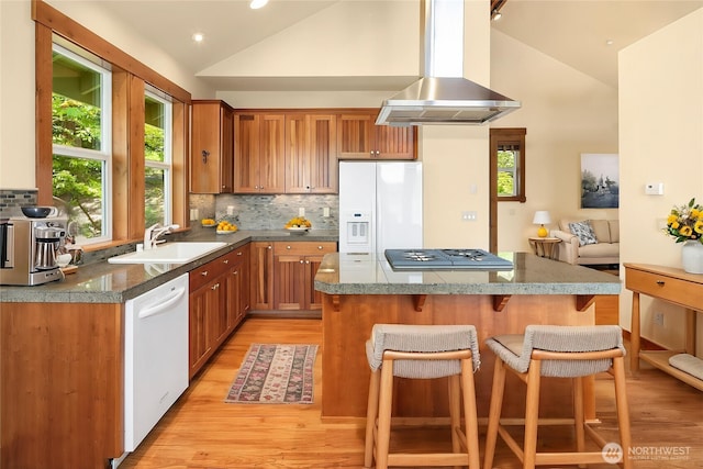 1624 Mallard Ln, Bellevue, WA 98008 - kitchen featuring white appliances, a sink, exhaust hood, a kitchen breakfast bar, and light wood-style floors