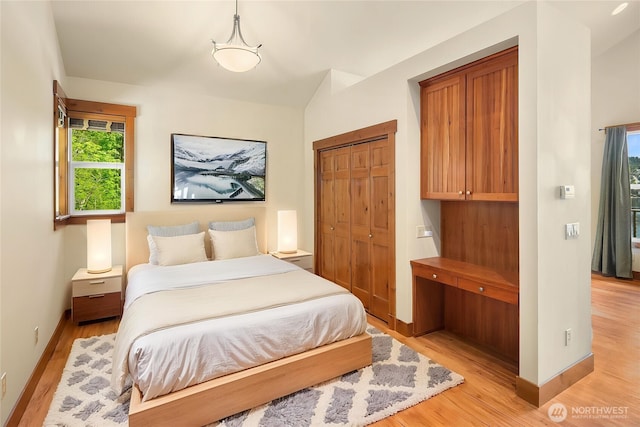 1624 Mallard Ln, Bellevue, WA 98008 - bedroom with light wood-style flooring, baseboards, and a closet
