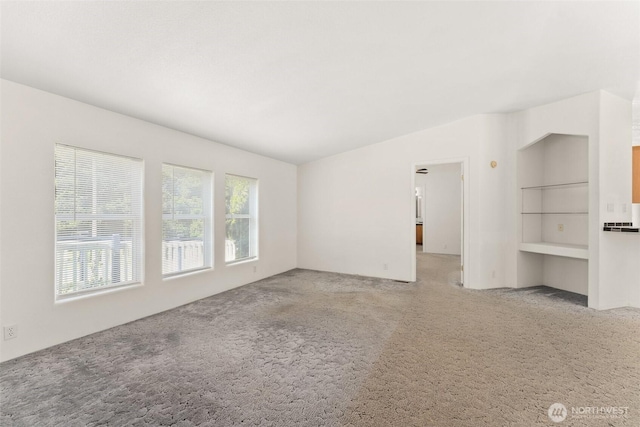 unfurnished living room featuring carpet