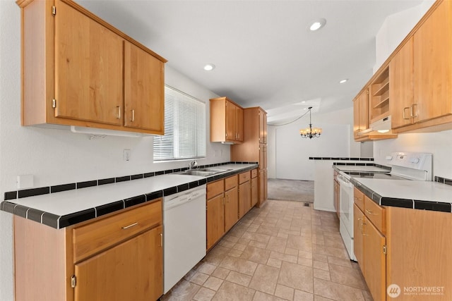 kitchen featuring white appliances, a sink, a chandelier, recessed lighting, and under cabinet range hood